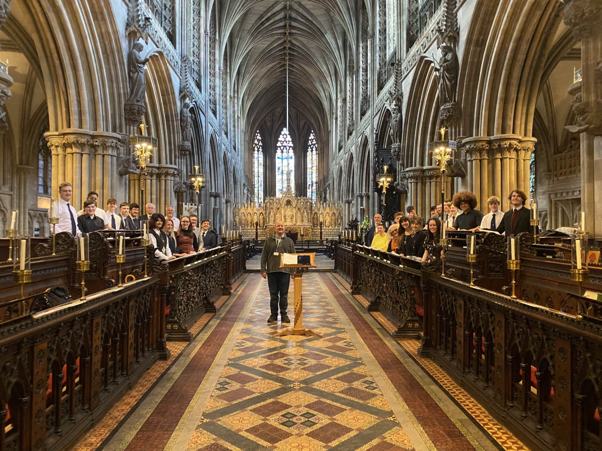 Alumni Evensong A photo of former choristers in the Quire stalls in Lichfield Cathedral with conductor Ben Lamb