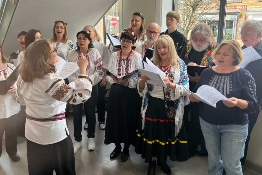 City of Sanctuary Choir A group of people singing as a choir