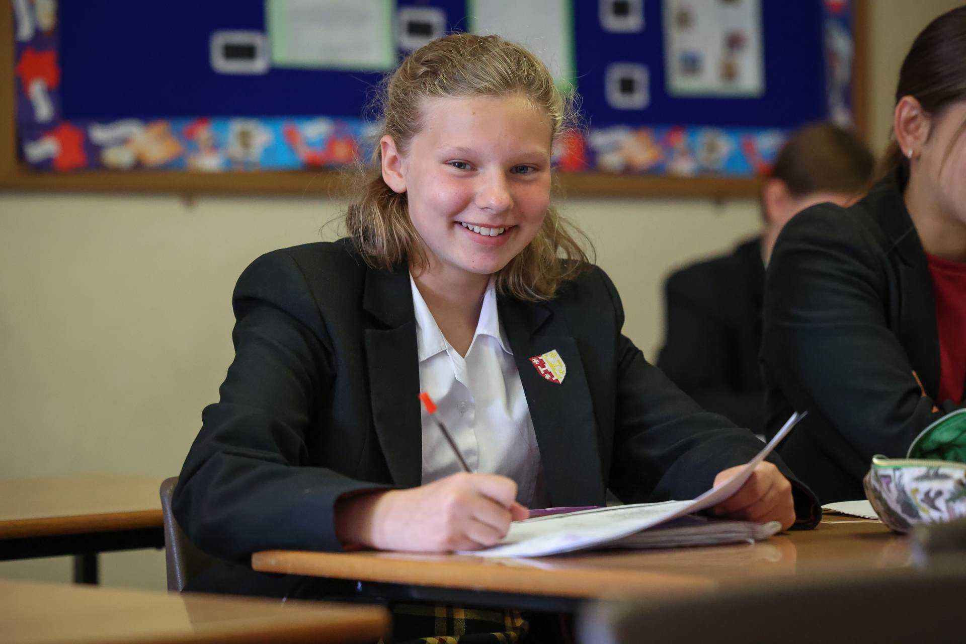 Smiling pupil at desk